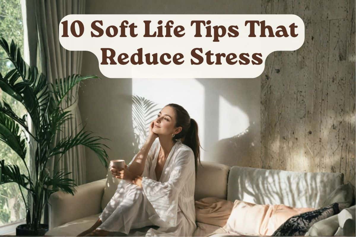 Woman sitting on a light-colored sofa in a sunlit room, holding a cup and gazing peacefully toward the window. Indoor plants and soft neutral decor create a calm, stress-free atmosphere. Text overlay reads: '10 Soft Life Tips That Reduce Stress'