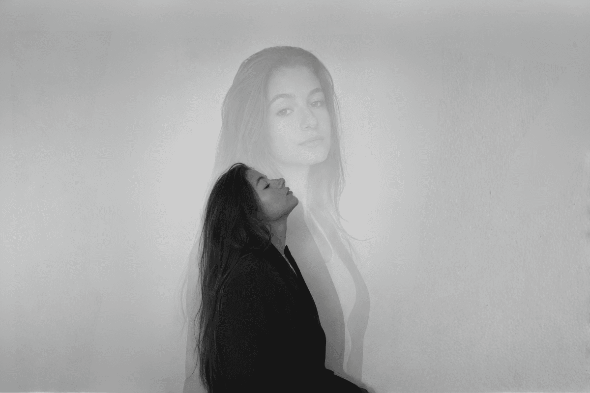A double‑exposure portrait of a woman in profile with eyes closed, symbolizing introspection and emotional balance.
