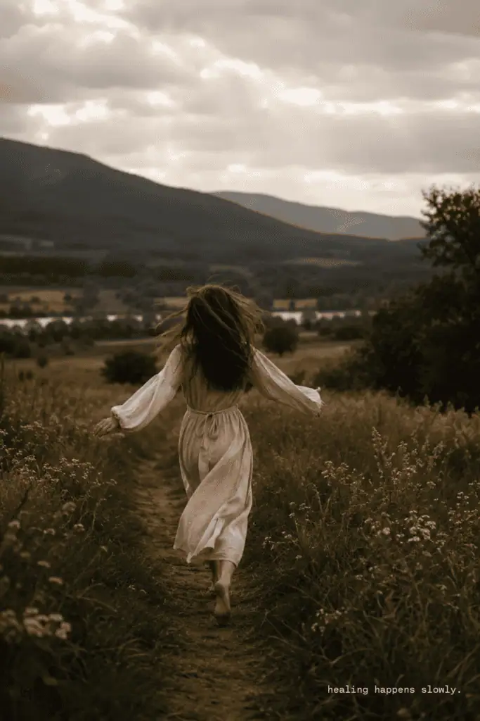 Anxiety relief represented by a woman walking barefoot on a countryside path surrounded by tall grass, symbolizing slow healing and grounding in nature.