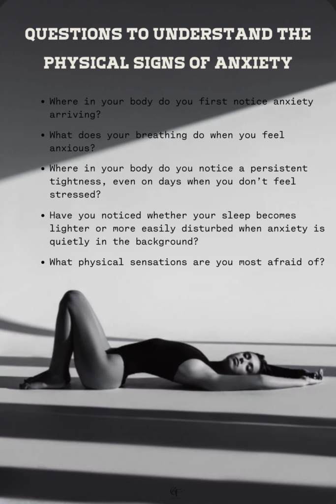 A grayscale image of a person lying on the floor with arms stretched overhead, light and shadow creating a dramatic mood. Text above the image lists questions about noticing physical signs of anxiety in the body.